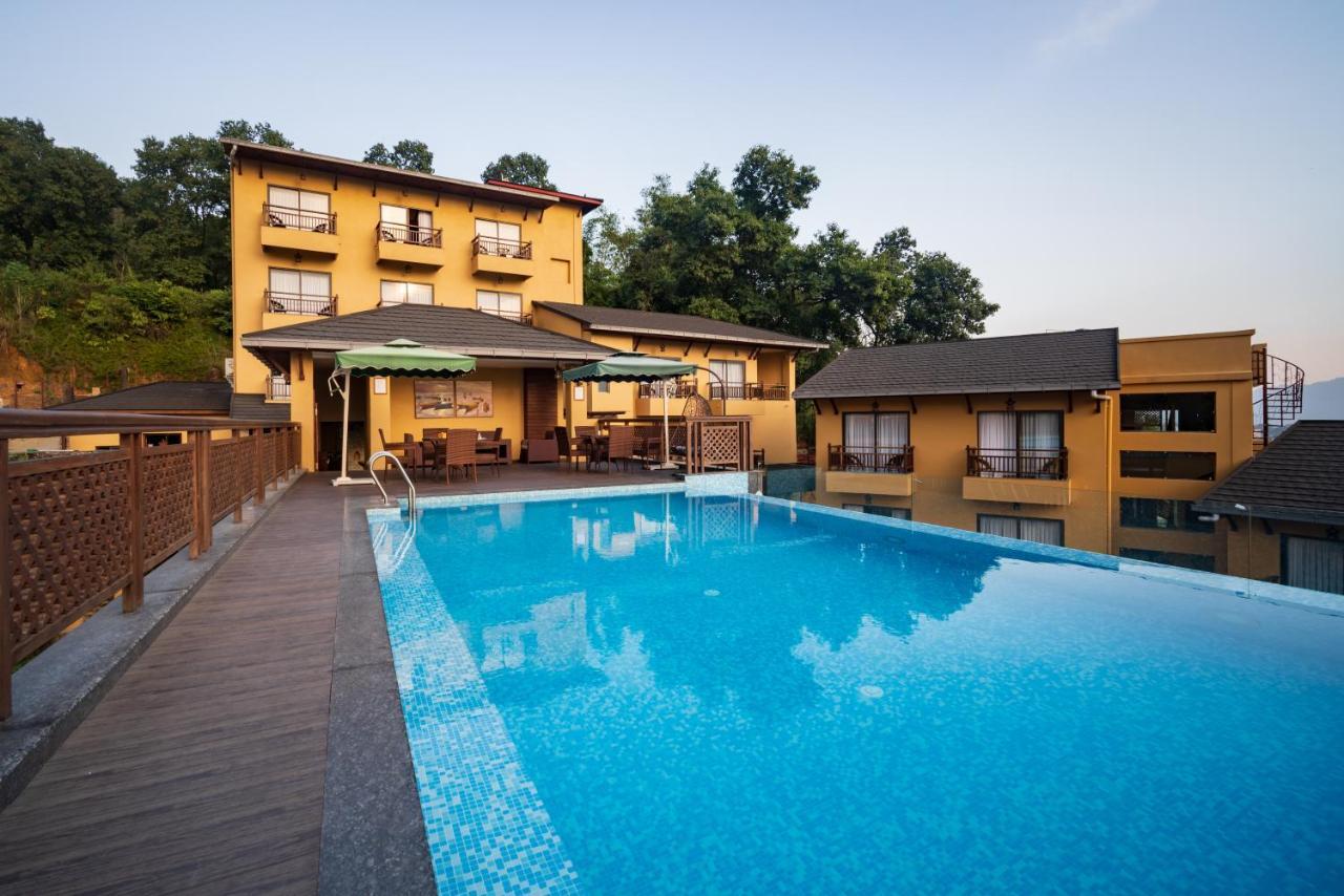 Bar Peepal Resort Покхара Экстерьер фото The swimming pool at the resort